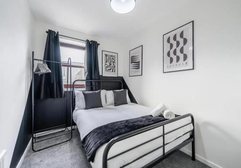 a bedroom with a bed and a window at Bright & Spacious 2BR Fraserburgh for Work & Family Stays in Fraserburgh