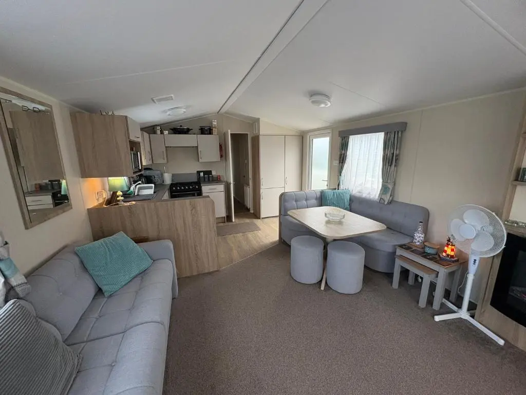 a living room with a couch and a table at Pebble Cove 74 in Lossiemouth