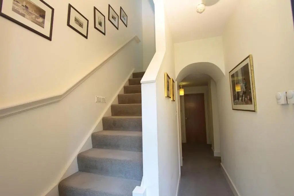 a staircase in a house with a stair case at Moat House 1 in Fort Augustus