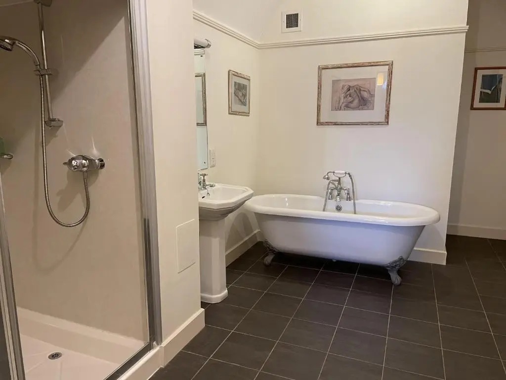 a bathroom with a tub and a sink at Moat House 1 in Fort Augustus