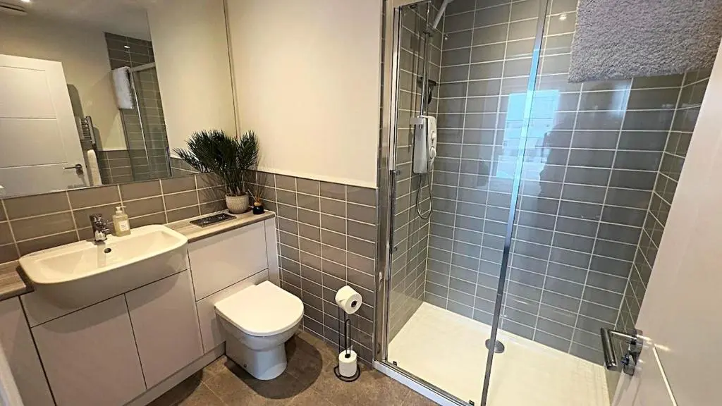 a bathroom with a shower and a toilet and a sink at High-Ness View in Inverness