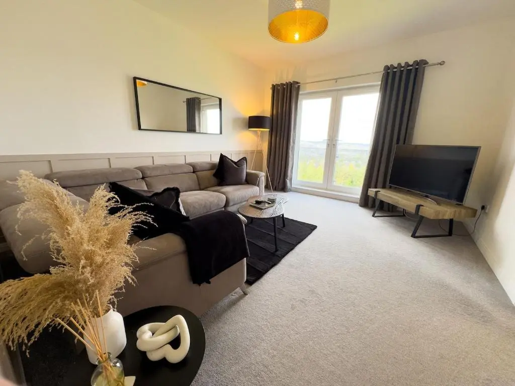 a living room with a couch and a television at High-Ness View in Inverness