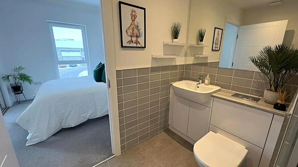 a bathroom with a bed and a sink and a toilet at High-Ness View in Inverness