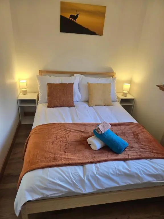 a bed with two pillows and a towel on it at The Highland Nook in South Kessock