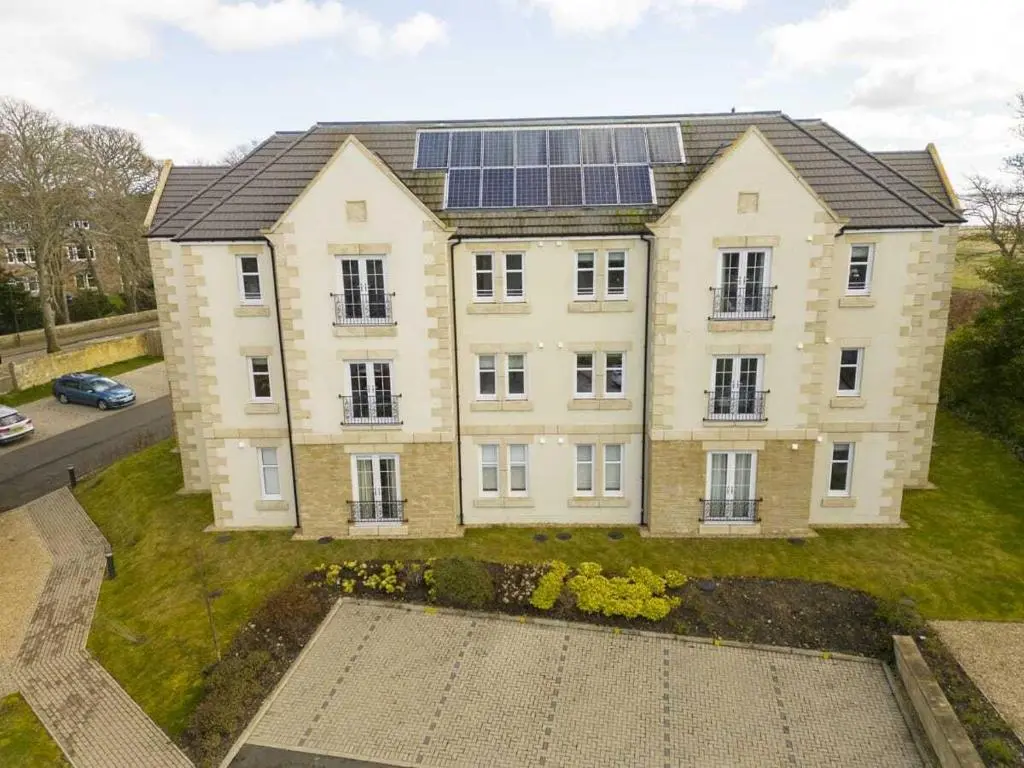 a large house with solar panels on top of it at Royal Gardens Apartment 19 in Dornoch