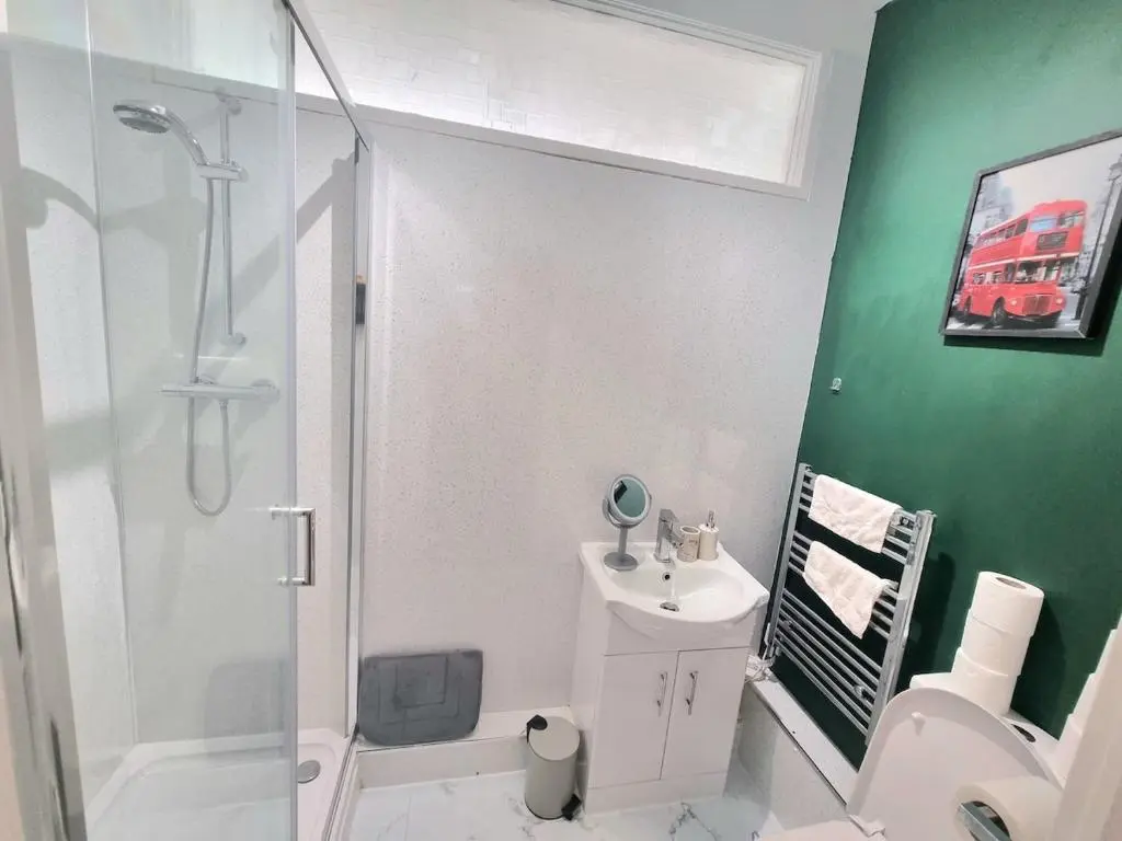 a bathroom with a shower and a toilet and a sink at 2 bedroom flat- 5 minutes walk from city centre in Inverness