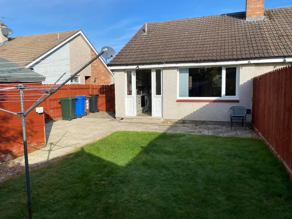 a house with a yard with a fence and a yard at Highland haven, free parking on driveway, near Raigmore Hospital in Inshes