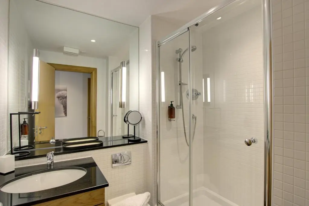 a bathroom with a sink and a shower at No8 The Links Apartment, Brora in Brora