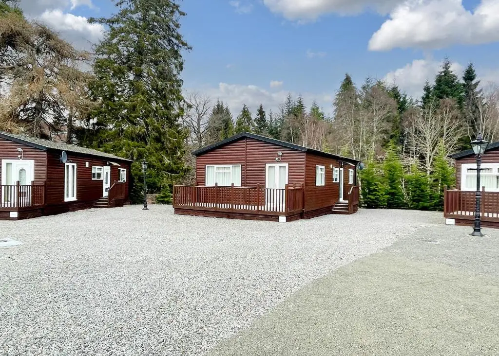 a couple of cabins in a parking lot at Calvine Holiday Park in Pitlochry