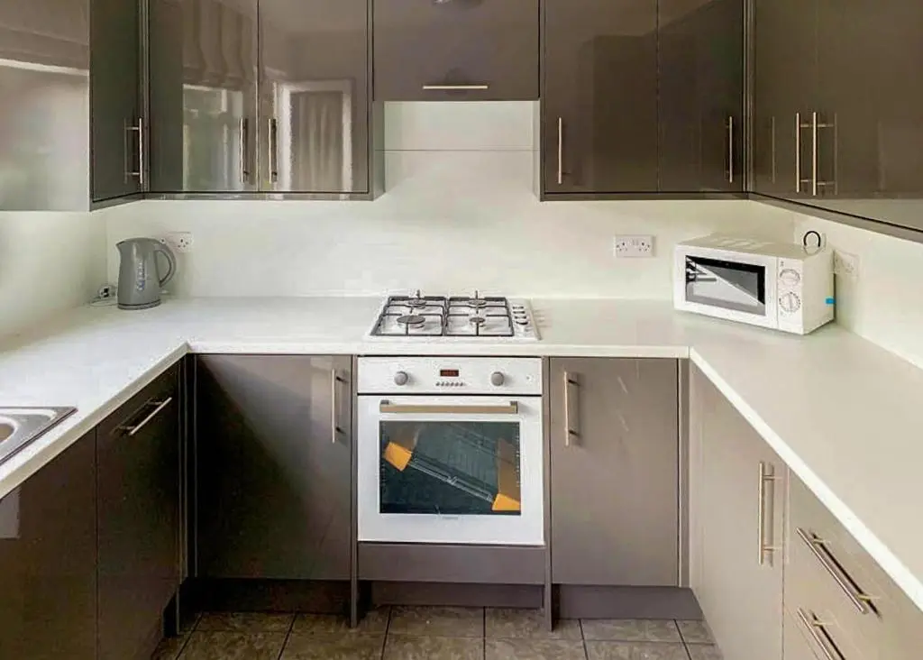 a kitchen with a stove and a microwave at Calvine Holiday Park in Pitlochry