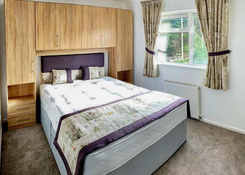 a bedroom with a large bed in a room at Calvine Holiday Park in Pitlochry