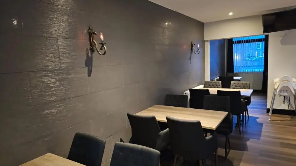 a dining room with wooden tables and chairs at Crown Hotel & Bar in Inverness