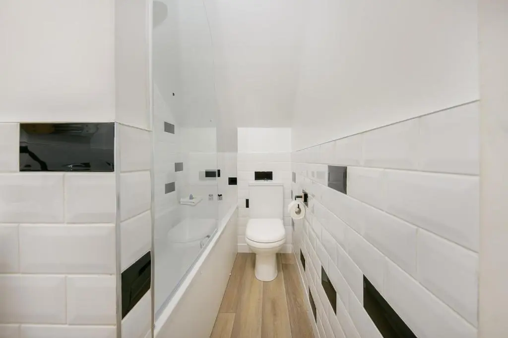 a white bathroom with a toilet and a sink at Rooemah Lodge - Grampian Lettings in Caskieben