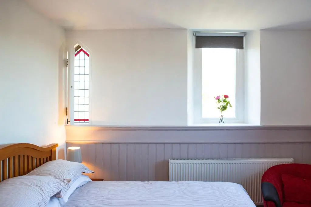a bedroom with a bed and a window at Old Church in Inverness