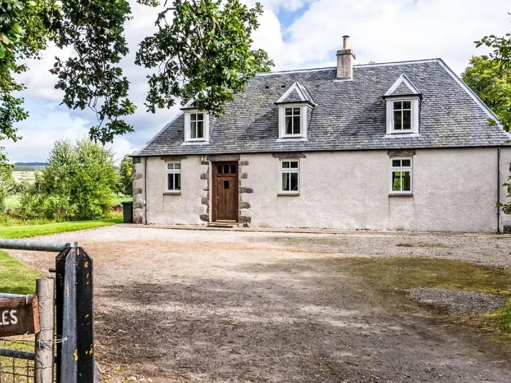 an old white house with a gate and a driveway at Holiday Home Corrimony View by Interhome in Drumnadrochit