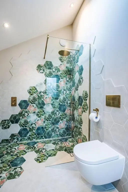 a bathroom with a toilet and a mosaic wall at Holiday Home Cooriedoon by Interhome in Hopeman