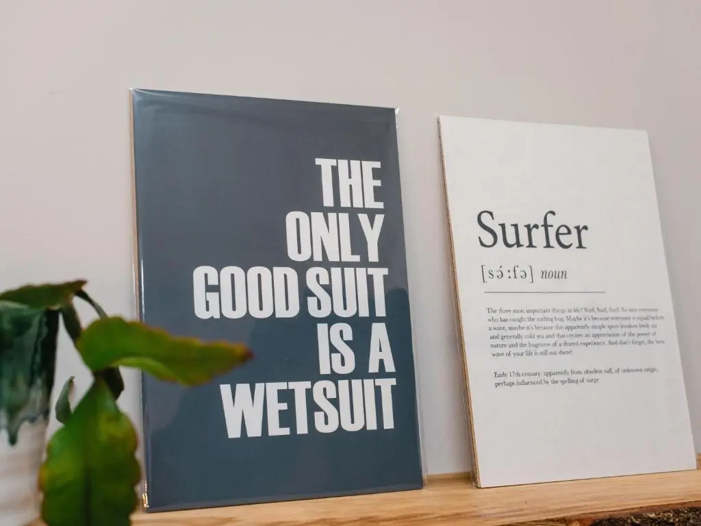 two books sitting on a shelf next to a plant at Holiday Home Cooriedoon by Interhome in Hopeman