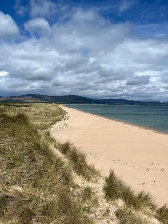 a sandy beach with the ocean in the background at Beautiful Highland Sanctuary in Embo