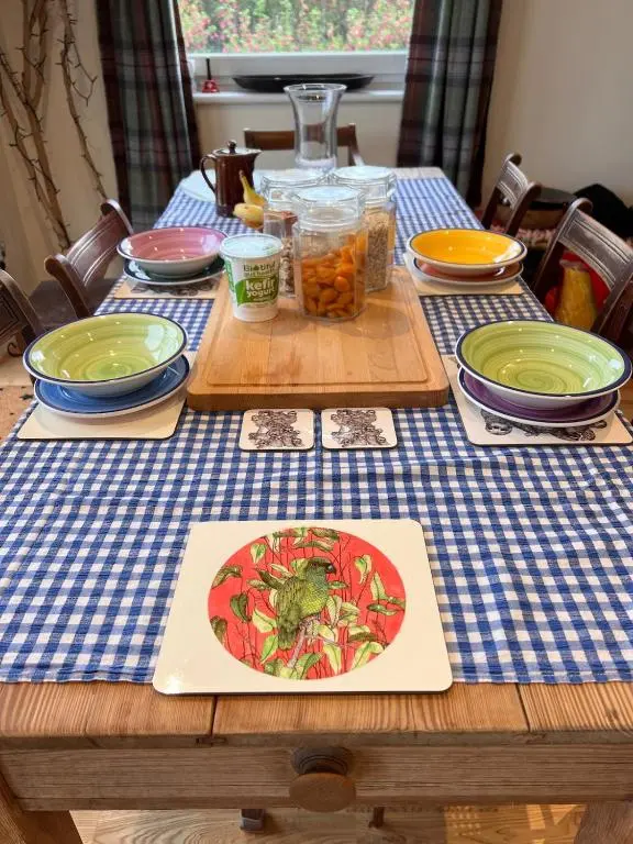 a table with a blue checkered table cloth with food on it at Beautiful Highland Sanctuary in Embo