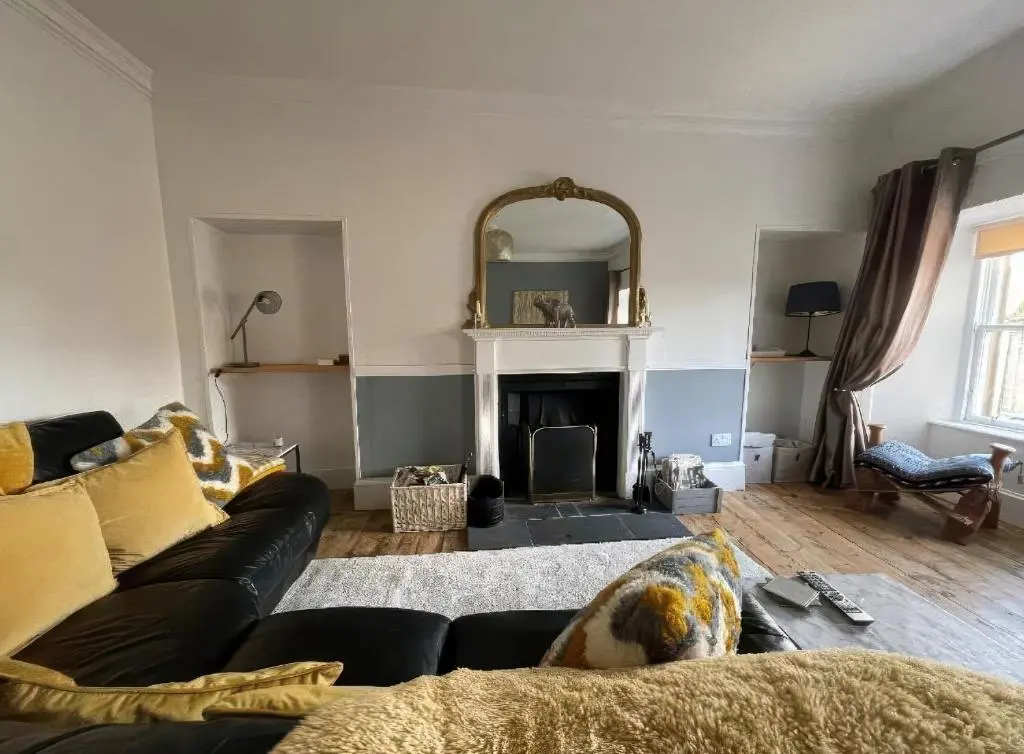 a living room with a couch and a fireplace at Home in Forres, Moray in Forres