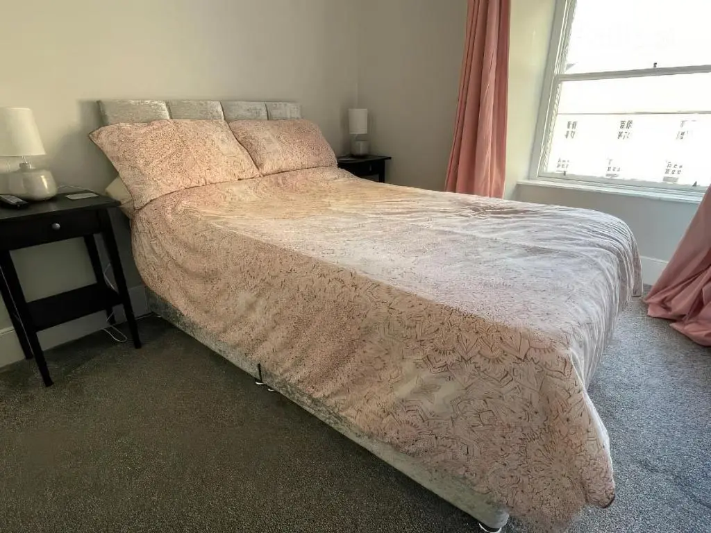 a large bed in a bedroom with a window at Home in Forres, Moray in Forres
