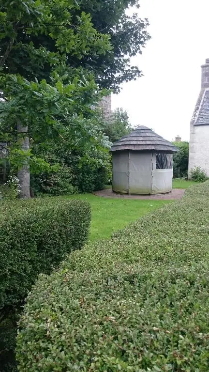 a gazebo sitting in the middle of a yard at Special Offer, Cosy Cottage Near the Sea in Embo in Embo