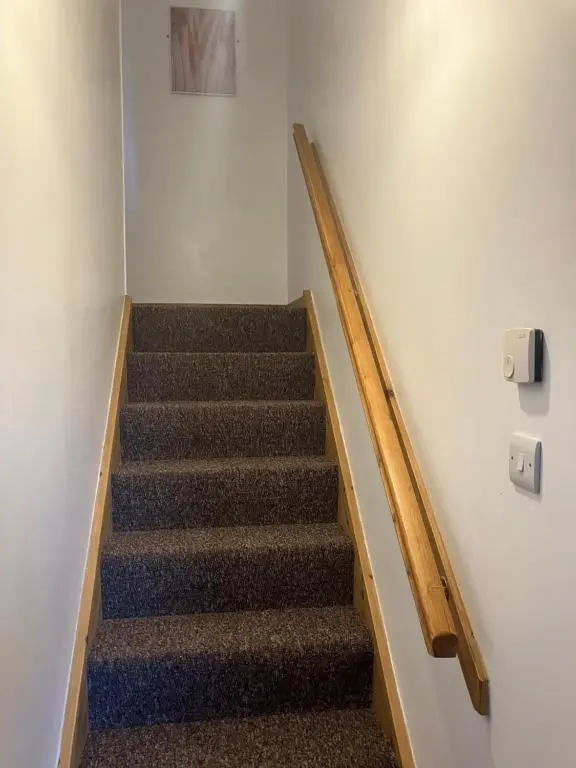 a staircase in a building with a stair case at Toll House in Wick
