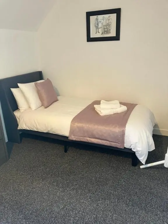 a bed with two pillows on it in a room at Toll House in Wick