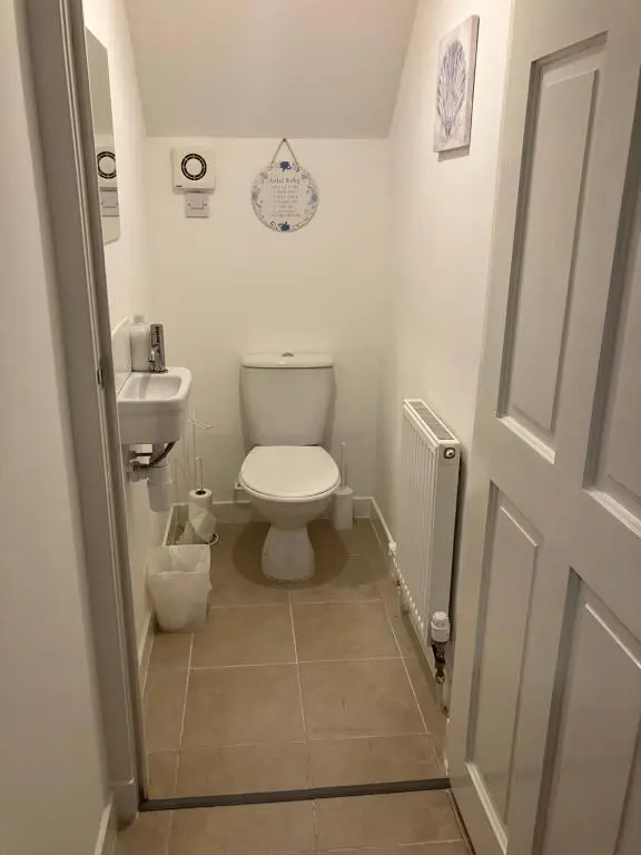 a small bathroom with a toilet and a sink at Toll House in Wick