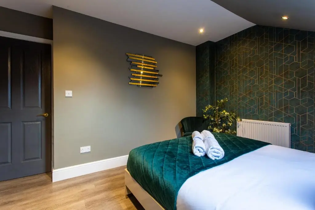 a bedroom with a bed with towels on it at 17 at the Bell Tower in Inverness