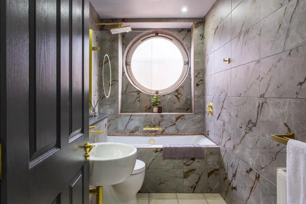 a bathroom with a sink toilet and a window at 17 at the Bell Tower in Inverness