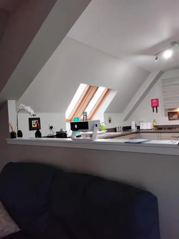a kitchen with a roof with skylights at Turfhill House in New Deer