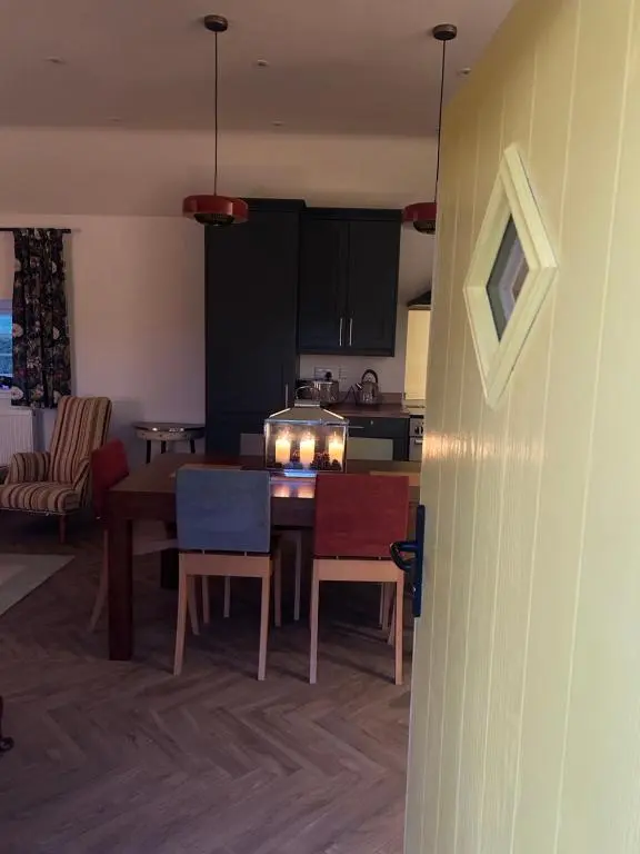 a kitchen and dining room with a table and chairs at Calsie Cottage, Clatt in Kirktown of Clatt