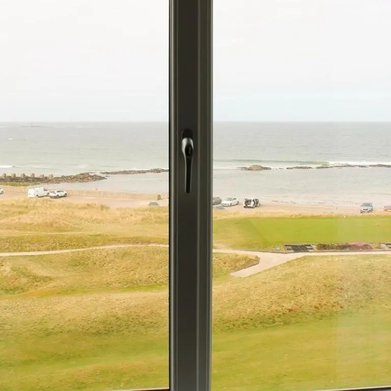 a window with a view of the ocean at Poseidon's in Lossiemouth