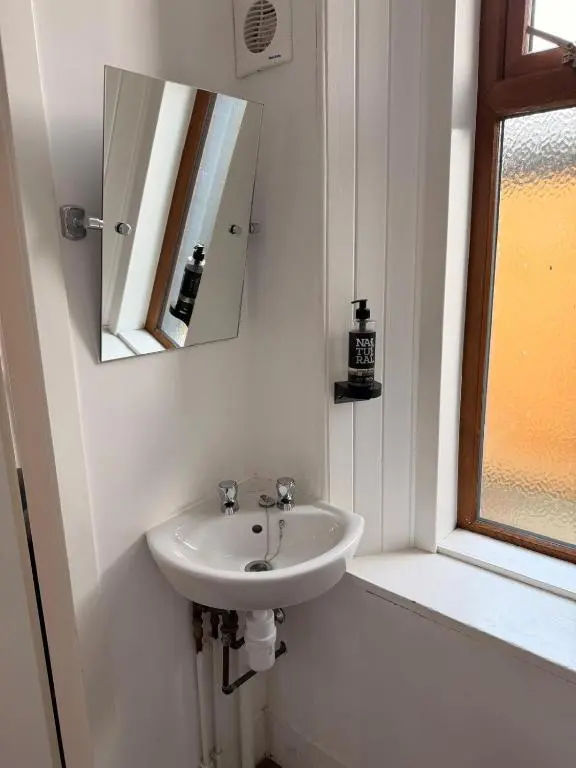 a bathroom with a sink and a mirror at Westend Hotel & Bar in Nairn