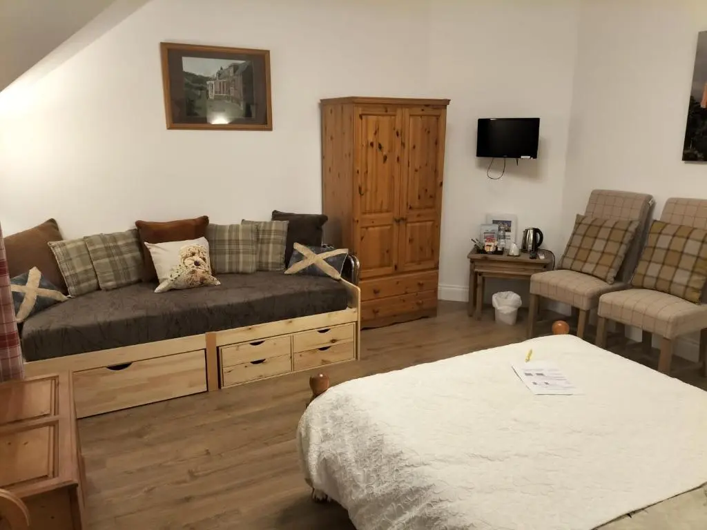 a living room with a couch and two chairs at Atherstone B&B in Inverness