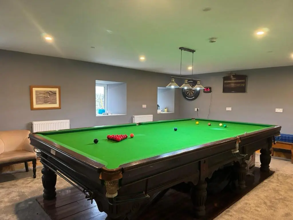 a room with a pool table with balls on it at Overscaig House in Lairg