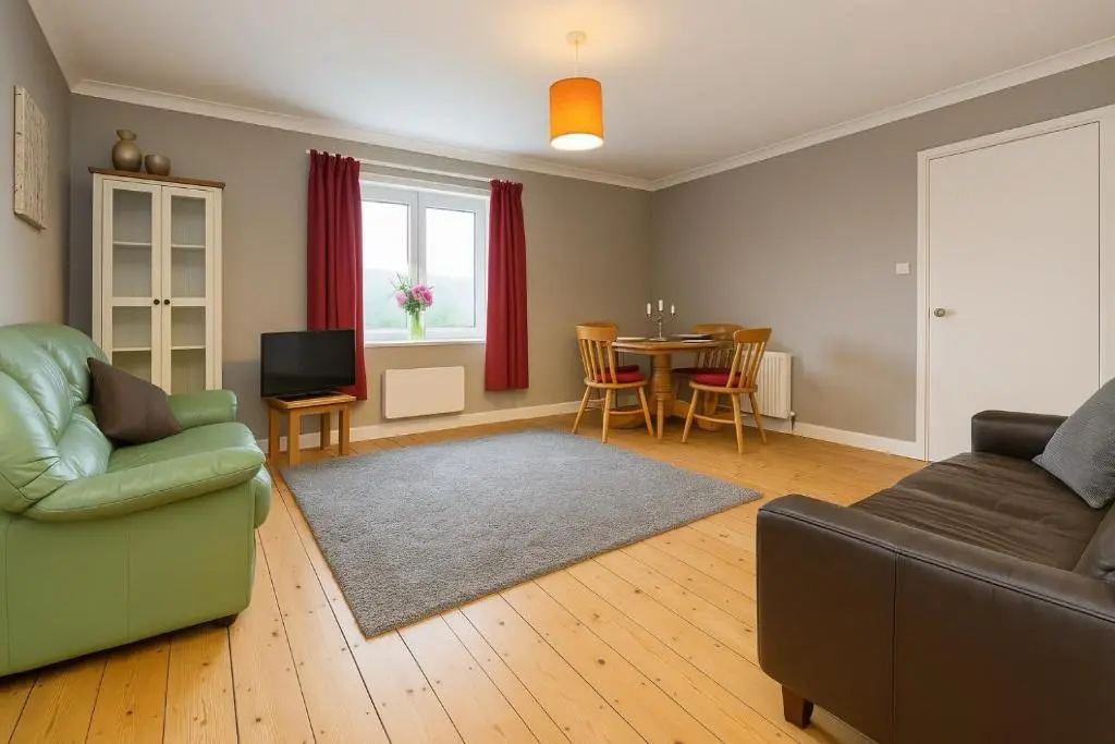 a living room with a couch and a table at Overscaig House - The Annexe in Lairg