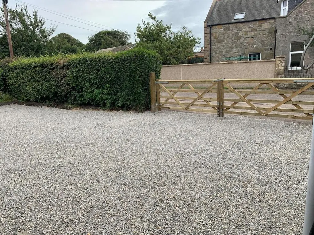 a wooden fence in front of a house at Glenerne 3 bedroom Cottage in Elgin