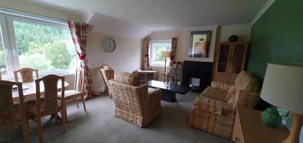 a living room with a couch and chairs and a window at River View in Garve