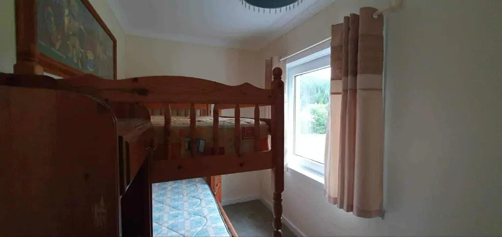 a room with a bunk bed and a window at River View in Garve