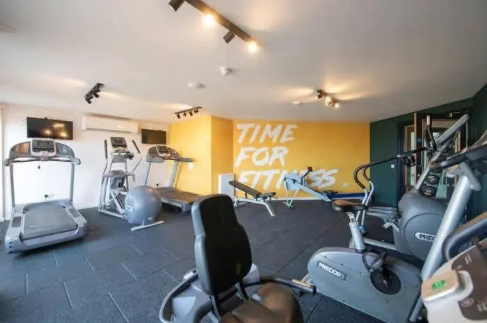 a gym with several exercise bikes in a room at Casa MALC Caravan in Lossiemouth