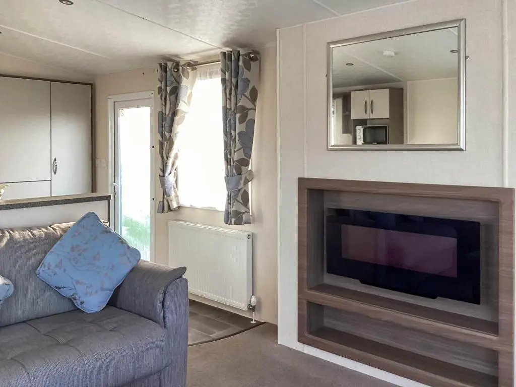 a living room with a couch and a flat screen tv at A Stone's Throw in Lossiemouth