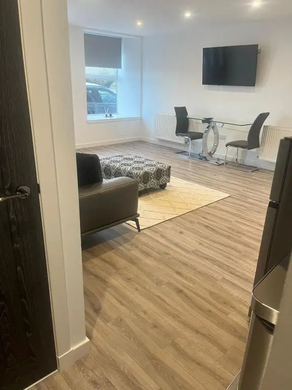 a living room with a couch and a table at Newly Renovated Luxuary Flat overlooking Wick Bay in Wick