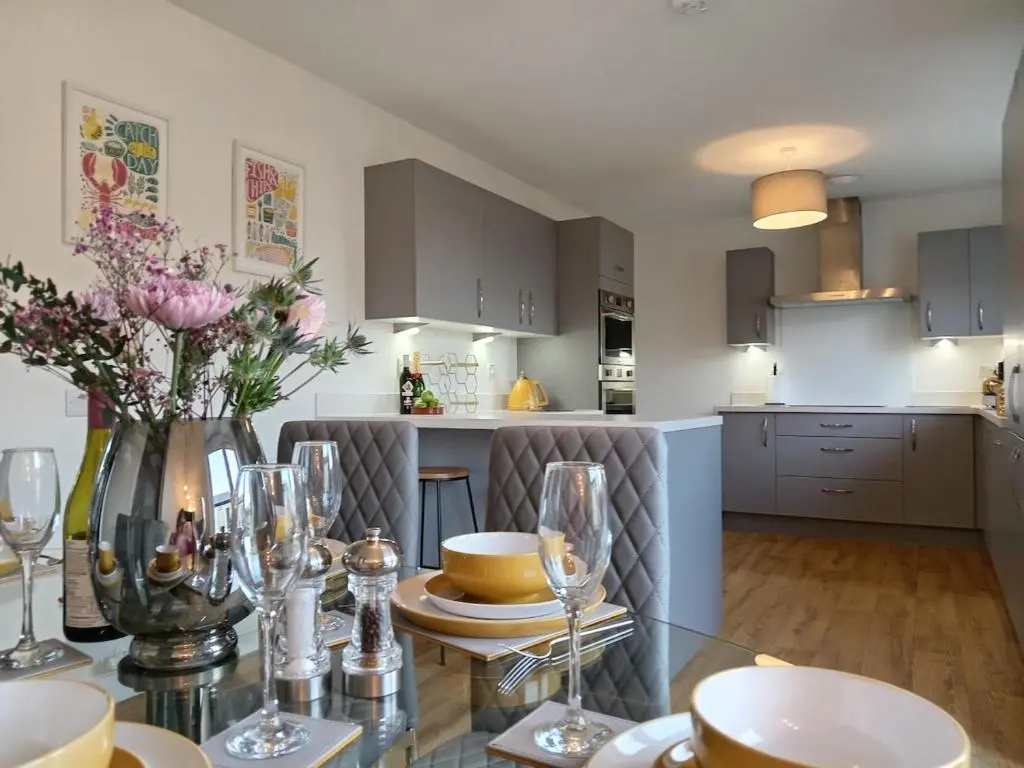 a kitchen with a glass table with flowers on it at Modern 4 Bed Highland Home in Culloden