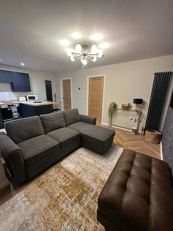 a living room with a couch and a table at Modern central apartment in Wick