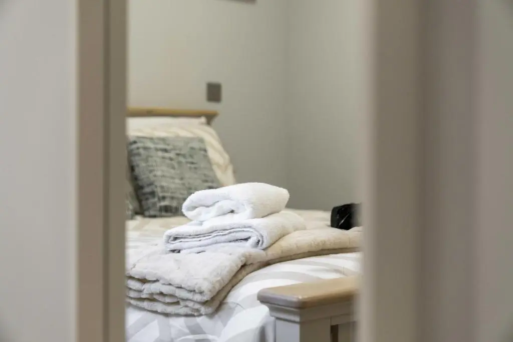 a pile of towels sitting on top of a bed at Temple 1 Bedroom Studio - Inverness in Inverness