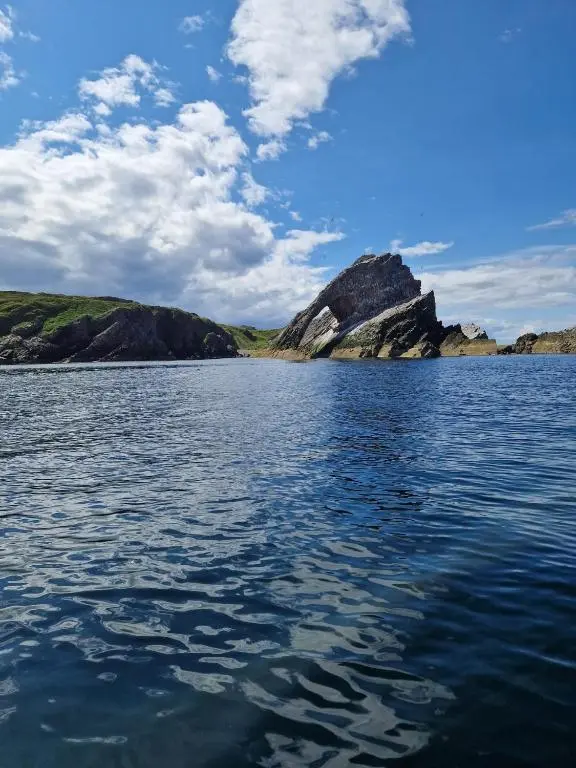 a large body of water with a mountain in the background at Serenity by the Sea in Buckie
