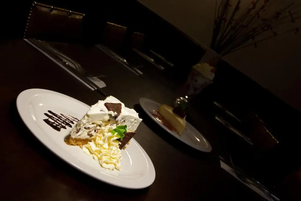 a piece of cake on a white plate with a fork at The Shandwick Inn in Tain