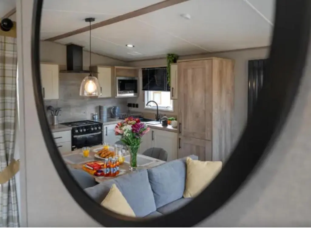 a view of a kitchen with a table in a mirror at ScottishHighlands in Boat of Garten